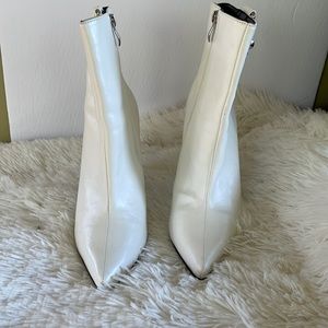 White ankle booties with silver buckle on the side